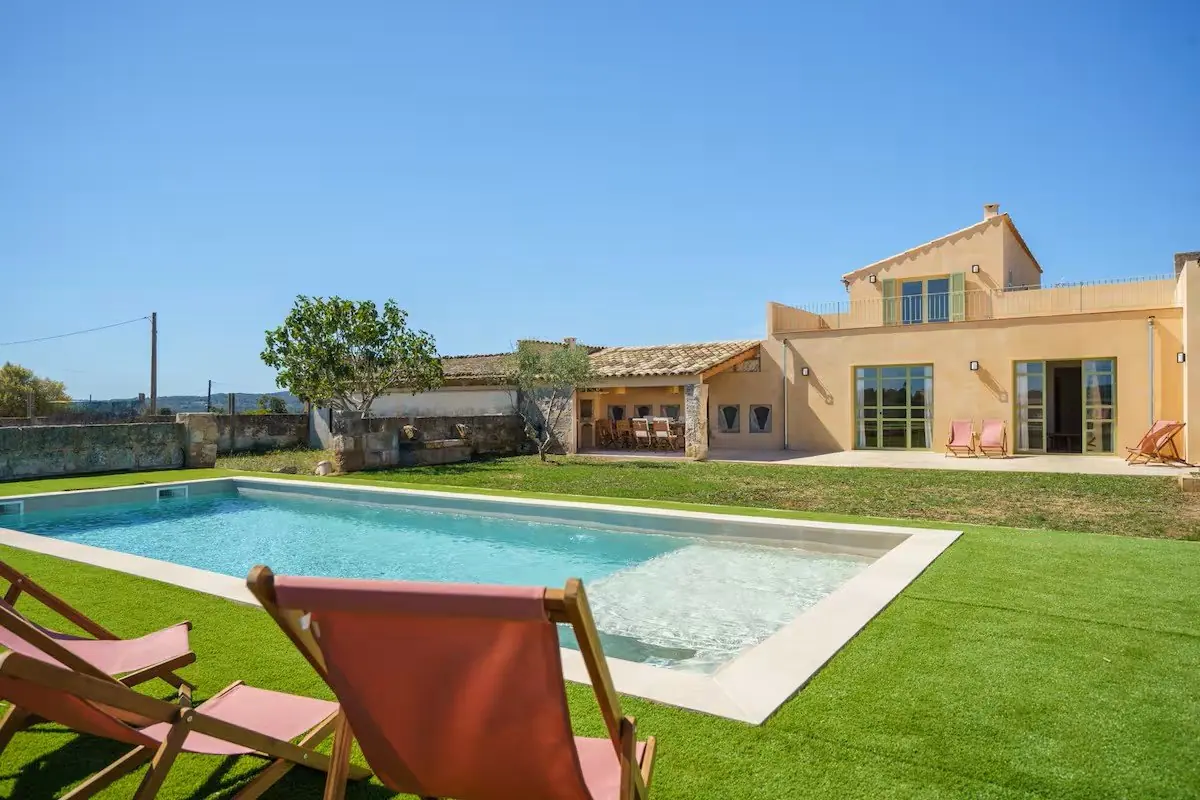 Photo of the pool and garden at Hostal des Bou